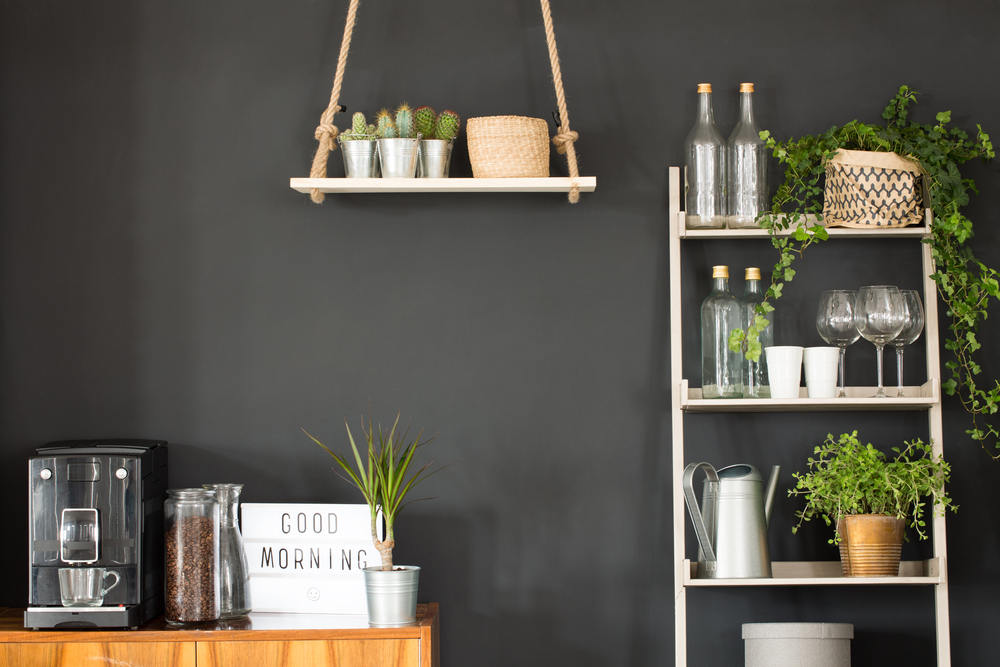 Modern kitchen with black wall, swing shelf and ladder bookcase